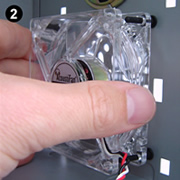 Fitting AFM02 antivibration ultra-soft fan mounts. Image 2 shows a clear low vibration fan (an AcoustiFan™ C-Series) being threaded from the inside of the PC onto fan mounts in position.